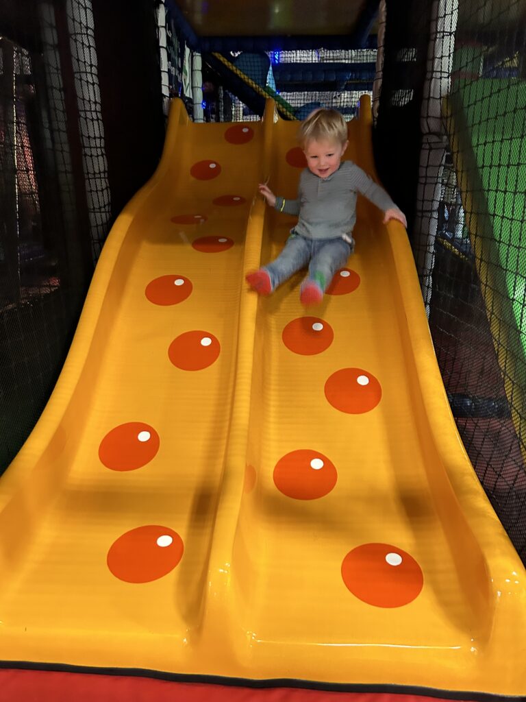 Boy enjoying the soft play slide